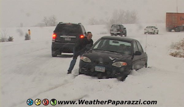 Winter storm footage, car in a ditch